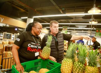 Angeline Bett, Area Manager for Carrefour Kenya and Christophe Orcet, Regional Director – East Africa at Majid Al Futtaim Retail, pictured beside a variety of pineapples during the grand opening of Carrefour's 25th store at Runda Mall