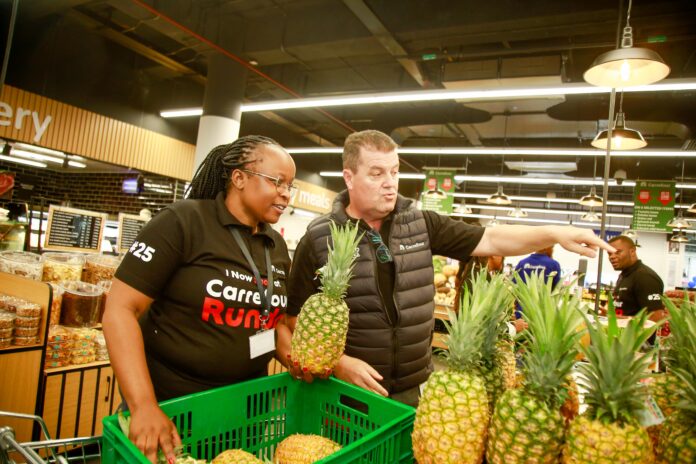 Angeline Bett, Area Manager for Carrefour Kenya and Christophe Orcet, Regional Director – East Africa at Majid Al Futtaim Retail, pictured beside a variety of pineapples during the grand opening of Carrefour's 25th store at Runda Mall