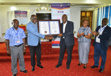 Mount Kenya University (MKU) is the first institution to be accredited to train Health Records professionals in the country after fulfilling all the requirements set by the Ministry of Health. The Director, Health Information Systems at the ministry, Mr. Gilbert Nzomo says the training of Health Records officers has come a long way as, initially, it was even done outside the country. “Many institutions are now training the officers and there is need to ensure quality. It started as a certificate programme and at the moment we have PhD programmes in the country,” he added. Speaking during the official presentation of certificate of accreditation to MKU, the Chairman, Health Records and Information Mangers Board, Mr. Onesmus K. Mwaura said MKU was the first institution to be accredited after fulfilling all the requirements. “As a board, we have embarked on streamlining the training of the health records and information officers in the country. One way of ensuring that all the institutions adhere to the set guidelines is through accreditation,” he said. Mr Mwaura said the Health Records and Information Managers Board (HRIM) is anchored in the HRIM Act No 15 of 2016 which became operational in 2022. “The act empowers the board to exercise regulatory and oversight roles on training institutions offering training in Health Records and Information courses,” he added. MKU vice-chancellor Prof. Deogratius Jaganyi, expressed gratitude to the Health Records and Information Managers Board (HRIMB) for the collaboration with his institution in the training of Health Records and Information Managers. “Universal access to quality health services and, in turn, improved health outcomes require not only more health professionals but also the quality and relevance of education in health professions,” he said. Accordingly, plans are underway to the process of launching a Master of Health Information Management Program. “MKU values the strong collaborative relationship that we share with the HRIM Board and remains committed to upholding the highest standards of training Health Records and Information management managers,” he added. MKU graduated its first Bachelor of Science in Health Records and Information Management graduates in December 2012. To date, the university has graduated 516 Bachelor of Science, 860 Diplomas and 383 certificates in Health Records and Information Management. “Our health records and information technology graduates are making an impact in diverse sectors including the government, Non-governmental Organisations, academia, and international bodies such the World Health Organisation,” noted the VC. Prof Jaganyi noted that the university remains committed to preparing the students to high quality professionals to serve as health care and quality managers at all levels of the healthcare ecosystem both locally and internationally. “Our programmes endeavour to expose our graduates to modern technology in the health records domain which ensures that they are capable of applying technology in the improvement of patient care and outcomes,” he added. Others who attended or were represented at the function were MKU’s Deputy Vice-Chancellor, Academic and Research Affairs, Dr Mercyline Kamande; Registrar, Academic Administration, Dr Ronald Maathai; Principal, College of Health Sciences, Dr. Josphat Njuguna; Dean, School of Clinical Medicine, Mr. Peter Mwaura, faculty members and students. The news of the certification comes a few days after the university was re-accredited by the Nursing Council of Kenya to continue training nursing students. The Institution has been offering a Bachelor of Science in Nursing degree for the last 12 years and has been subject to regular reviews by the nursing council to confirm that the university’s facilities, including laboratories, meet the set requirements. The reviews undertaken every five years are a legal requirement for all institutions of higher learning training nursing students. The Registrar Nursing Council of Kenya Dr. Lister Onsongo presented the re-accreditation certificate to the MKU Vice-Chancellor Prof. Deogratious Jaganyi.