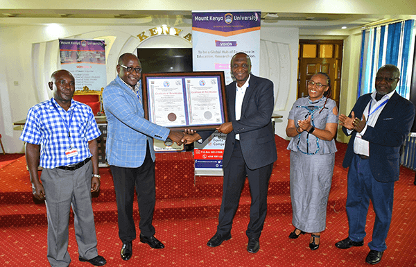 Mount Kenya University (MKU) is the first institution to be accredited to train Health Records professionals in the country after fulfilling all the requirements set by the Ministry of Health. The Director, Health Information Systems at the ministry, Mr. Gilbert Nzomo says the training of Health Records officers has come a long way as, initially, it was even done outside the country. “Many institutions are now training the officers and there is need to ensure quality. It started as a certificate programme and at the moment we have PhD programmes in the country,” he added. Speaking during the official presentation of certificate of accreditation to MKU, the Chairman, Health Records and Information Mangers Board, Mr. Onesmus K. Mwaura said MKU was the first institution to be accredited after fulfilling all the requirements. “As a board, we have embarked on streamlining the training of the health records and information officers in the country. One way of ensuring that all the institutions adhere to the set guidelines is through accreditation,” he said. Mr Mwaura said the Health Records and Information Managers Board (HRIM) is anchored in the HRIM Act No 15 of 2016 which became operational in 2022. “The act empowers the board to exercise regulatory and oversight roles on training institutions offering training in Health Records and Information courses,” he added. MKU vice-chancellor Prof. Deogratius Jaganyi, expressed gratitude to the Health Records and Information Managers Board (HRIMB) for the collaboration with his institution in the training of Health Records and Information Managers. “Universal access to quality health services and, in turn, improved health outcomes require not only more health professionals but also the quality and relevance of education in health professions,” he said. Accordingly, plans are underway to the process of launching a Master of Health Information Management Program. “MKU values the strong collaborative relationship that we share with the HRIM Board and remains committed to upholding the highest standards of training Health Records and Information management managers,” he added. MKU graduated its first Bachelor of Science in Health Records and Information Management graduates in December 2012. To date, the university has graduated 516 Bachelor of Science, 860 Diplomas and 383 certificates in Health Records and Information Management. “Our health records and information technology graduates are making an impact in diverse sectors including the government, Non-governmental Organisations, academia, and international bodies such the World Health Organisation,” noted the VC. Prof Jaganyi noted that the university remains committed to preparing the students to high quality professionals to serve as health care and quality managers at all levels of the healthcare ecosystem both locally and internationally. “Our programmes endeavour to expose our graduates to modern technology in the health records domain which ensures that they are capable of applying technology in the improvement of patient care and outcomes,” he added. Others who attended or were represented at the function were MKU’s Deputy Vice-Chancellor, Academic and Research Affairs, Dr Mercyline Kamande; Registrar, Academic Administration, Dr Ronald Maathai; Principal, College of Health Sciences, Dr. Josphat Njuguna; Dean, School of Clinical Medicine, Mr. Peter Mwaura, faculty members and students. The news of the certification comes a few days after the university was re-accredited by the Nursing Council of Kenya to continue training nursing students. The Institution has been offering a Bachelor of Science in Nursing degree for the last 12 years and has been subject to regular reviews by the nursing council to confirm that the university’s facilities, including laboratories, meet the set requirements. The reviews undertaken every five years are a legal requirement for all institutions of higher learning training nursing students. The Registrar Nursing Council of Kenya Dr. Lister Onsongo presented the re-accreditation certificate to the MKU Vice-Chancellor Prof. Deogratious Jaganyi.