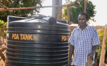 Dennis Ngari, a resident of Rianjeru village in Embu County, faced significant challenges due to water scarcity in the semi-arid region. The community depended on a World Bank-funded water project, which often ran dry during the harsh dry seasons. As the sole breadwinner, Dennis struggled to provide enough water for his farm and his family's needs, forcing him to make long trips on his boda-boda to fetch water from distant sources. His farm, located near a river, had to compete with other farmers for the limited water supply, leaving his family in a constant struggle. In February 2021, Dennis found a lifeline through BIMAS microfinance. He received a loan of Ksh 42,000 to buy and install a 6,000-liter water tank at his home. This loan transformed his life. With a reliable water supply, Dennis's farm flourished, and his boda-boda business stabilized. The constant access to water allowed him to tend to his crops year-round, even during the dry seasons. Now, Dennis and his family are planning to expand their business, aiming for another loan to purchase a 10,000-liter tank to ensure an ample water supply for their growing farm. Grateful for the support, Dennis says, "BIMAS came to my rescue when I was about to give up on farming. Now, I can farm in all seasons without worrying if the rivers run dry. My farming business has flourished since joining hands with BIMAS. We can nurture our farm day or night, rain or shine." Dennis's story is a shining example of the positive impact BIMAS has had on his life and his family's future.