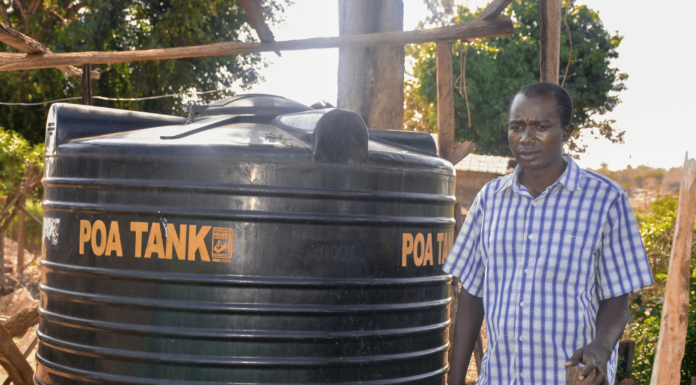 Dennis Ngari, a resident of Rianjeru village in Embu County, faced significant challenges due to water scarcity in the semi-arid region. The community depended on a World Bank-funded water project, which often ran dry during the harsh dry seasons. As the sole breadwinner, Dennis struggled to provide enough water for his farm and his family's needs, forcing him to make long trips on his boda-boda to fetch water from distant sources. His farm, located near a river, had to compete with other farmers for the limited water supply, leaving his family in a constant struggle. In February 2021, Dennis found a lifeline through BIMAS microfinance. He received a loan of Ksh 42,000 to buy and install a 6,000-liter water tank at his home. This loan transformed his life. With a reliable water supply, Dennis's farm flourished, and his boda-boda business stabilized. The constant access to water allowed him to tend to his crops year-round, even during the dry seasons. Now, Dennis and his family are planning to expand their business, aiming for another loan to purchase a 10,000-liter tank to ensure an ample water supply for their growing farm. Grateful for the support, Dennis says, "BIMAS came to my rescue when I was about to give up on farming. Now, I can farm in all seasons without worrying if the rivers run dry. My farming business has flourished since joining hands with BIMAS. We can nurture our farm day or night, rain or shine." Dennis's story is a shining example of the positive impact BIMAS has had on his life and his family's future.