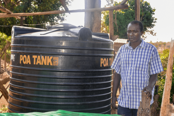 Dennis Ngari, a resident of Rianjeru village in Embu County, faced significant challenges due to water scarcity in the semi-arid region. The community depended on a World Bank-funded water project, which often ran dry during the harsh dry seasons. As the sole breadwinner, Dennis struggled to provide enough water for his farm and his family's needs, forcing him to make long trips on his boda-boda to fetch water from distant sources. His farm, located near a river, had to compete with other farmers for the limited water supply, leaving his family in a constant struggle. In February 2021, Dennis found a lifeline through BIMAS microfinance. He received a loan of Ksh 42,000 to buy and install a 6,000-liter water tank at his home. This loan transformed his life. With a reliable water supply, Dennis's farm flourished, and his boda-boda business stabilized. The constant access to water allowed him to tend to his crops year-round, even during the dry seasons. Now, Dennis and his family are planning to expand their business, aiming for another loan to purchase a 10,000-liter tank to ensure an ample water supply for their growing farm. Grateful for the support, Dennis says, 