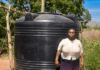 Meet Teresia, a resilient woman from Kiamuringa village in Gachoka location, Embu County who has defied adversity to secure a brighter future for her family. With five children to care for, Teresia took on the role of the family's sole provider, juggling various income streams from poultry and miraa farming to brick manufacturing. Her determination knew no bounds as she aspired to become a landlady in her community. In Kiamuringa, a semi-arid region, clean water was once a distant dream. Villagers had to trek two kilometers in search of boreholes, which often ran dry. To ensure her children's access to water, Teresia's young ones would wake up at 4 am daily to avoid the long queues, forcing Teresia's children to rise before dawn, braving long queues, their education hanging by a thread. Moreover, the exposed boreholes posed health risks due to waterborne diseases.  Frustrated by this situation, Teresia turned to BIMAS microfinance. She had been a loyal member for years, securing loans to nurture her miraa, poultry, and brick businesses. She recognized that hens, miraa, and brickmaking all demanded copious amounts of water for success. In January 2021, a ray of hope emerged as Teresia learnt that BIMAS was offering financing for water tanks to its customers. She seized this opportunity and secured a Ksh 27,000 loan to purchase and install a 4,000-liter water tank in her home. Additionally, BIMAS assisted her in acquiring a water pump worth Ksh 50,000. These investments proved to be game-changers, allowing her to operate her businesses seamlessly even during dry seasons. Today, Teresia's life has undergone an admirable transformation. She is not only a content mother but also a generous neighbor who shares her reservoir's abundance with the community. Her children's education has significantly improved as they can now focus on their studies without the burden of water-fetching. Furthermore, access to clean water has enhanced their health and overall well-being. Teresia's entrepreneurial spirit has thrived with BIMAS's support, leading to the establishment of a rental business on her property. Her success story is a proof to how access to clean water can unlock opportunities and improve lives. With a radiant smile, she expresses her gratitude, saying, "BIMAS has brought joy into my life, and I am delighted to see my neighbors benefit as well. I eagerly look forward to securing financing for another 6,000-liter water tank for my rental premises." Teresia's journey to water prosperity is an inspiration to us all.