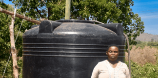 Meet Teresia, a resilient woman from Kiamuringa village in Gachoka location, Embu County who has defied adversity to secure a brighter future for her family. With five children to care for, Teresia took on the role of the family's sole provider, juggling various income streams from poultry and miraa farming to brick manufacturing. Her determination knew no bounds as she aspired to become a landlady in her community. In Kiamuringa, a semi-arid region, clean water was once a distant dream. Villagers had to trek two kilometers in search of boreholes, which often ran dry. To ensure her children's access to water, Teresia's young ones would wake up at 4 am daily to avoid the long queues, forcing Teresia's children to rise before dawn, braving long queues, their education hanging by a thread. Moreover, the exposed boreholes posed health risks due to waterborne diseases.  Frustrated by this situation, Teresia turned to BIMAS microfinance. She had been a loyal member for years, securing loans to nurture her miraa, poultry, and brick businesses. She recognized that hens, miraa, and brickmaking all demanded copious amounts of water for success. In January 2021, a ray of hope emerged as Teresia learnt that BIMAS was offering financing for water tanks to its customers. She seized this opportunity and secured a Ksh 27,000 loan to purchase and install a 4,000-liter water tank in her home. Additionally, BIMAS assisted her in acquiring a water pump worth Ksh 50,000. These investments proved to be game-changers, allowing her to operate her businesses seamlessly even during dry seasons. Today, Teresia's life has undergone an admirable transformation. She is not only a content mother but also a generous neighbor who shares her reservoir's abundance with the community. Her children's education has significantly improved as they can now focus on their studies without the burden of water-fetching. Furthermore, access to clean water has enhanced their health and overall well-being. Teresia's entrepreneurial spirit has thrived with BIMAS's support, leading to the establishment of a rental business on her property. Her success story is a proof to how access to clean water can unlock opportunities and improve lives. With a radiant smile, she expresses her gratitude, saying, "BIMAS has brought joy into my life, and I am delighted to see my neighbors benefit as well. I eagerly look forward to securing financing for another 6,000-liter water tank for my rental premises." Teresia's journey to water prosperity is an inspiration to us all.