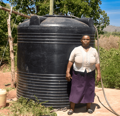 Bimas Microfinance Impact Stories: GIVING BRIGHT FUTURES TODAY Meet Teresia, a resilient woman from Kiamuringa village in Gachoka location, Embu County who has defied adversity to secure a brighter future for her family. With five children to care for, Teresia took on the role of the family's sole provider, juggling various income streams from poultry and miraa farming to brick manufacturing. Her determination knew no bounds as she aspired to become a landlady in her community. In Kiamuringa, a semi-arid region, clean water was once a distant dream. Villagers had to trek two kilometers in search of boreholes, which often ran dry. To ensure her children's access to water, Teresia's young ones would wake up at 4 am daily to avoid the long queues, forcing Teresia's children to rise before dawn, braving long queues, their education hanging by a thread. Moreover, the exposed boreholes posed health risks due to waterborne diseases. Frustrated by this situation, Teresia turned to BIMAS microfinance. She had been a loyal member for years, securing loans to nurture her miraa, poultry, and brick businesses. She recognized that hens, miraa, and brickmaking all demanded copious amounts of water for success. In January 2021, a ray of hope emerged as Teresia learnt that BIMAS was offering financing for water tanks to its customers. She seized this opportunity and secured a Ksh 27,000 loan to purchase and install a 4,000-liter water tank in her home. Additionally, BIMAS assisted her in acquiring a water pump worth Ksh 50,000. These investments proved to be game-changers, allowing her to operate her businesses seamlessly even during dry seasons. Today, Teresia's life has undergone an admirable transformation. She is not only a content mother but also a generous neighbor who shares her reservoir's abundance with the community. Her children's education has significantly improved as they can now focus on their studies without the burden of water-fetching. Furthermore, access to clean water has enhanced their health and overall well-being. Teresia's entrepreneurial spirit has thrived with BIMAS's support, leading to the establishment of a rental business on her property. Her success story is a proof to how access to clean water can unlock opportunities and improve lives. With a radiant smile, she expresses her gratitude, saying, "BIMAS has brought joy into my life, and I am delighted to see my neighbors benefit as well. I eagerly look forward to securing financing for another 6,000-liter water tank for my rental premises." Teresia's journey to water prosperity is an inspiration to us all.