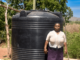 Meet Teresia, a resilient woman from Kiamuringa village in Gachoka location, Embu County who has defied adversity to secure a brighter future for her family. With five children to care for, Teresia took on the role of the family's sole provider, juggling various income streams from poultry and miraa farming to brick manufacturing. Her determination knew no bounds as she aspired to become a landlady in her community. In Kiamuringa, a semi-arid region, clean water was once a distant dream. Villagers had to trek two kilometers in search of boreholes, which often ran dry. To ensure her children's access to water, Teresia's young ones would wake up at 4 am daily to avoid the long queues, forcing Teresia's children to rise before dawn, braving long queues, their education hanging by a thread. Moreover, the exposed boreholes posed health risks due to waterborne diseases.  Frustrated by this situation, Teresia turned to BIMAS microfinance. She had been a loyal member for years, securing loans to nurture her miraa, poultry, and brick businesses. She recognized that hens, miraa, and brickmaking all demanded copious amounts of water for success. In January 2021, a ray of hope emerged as Teresia learnt that BIMAS was offering financing for water tanks to its customers. She seized this opportunity and secured a Ksh 27,000 loan to purchase and install a 4,000-liter water tank in her home. Additionally, BIMAS assisted her in acquiring a water pump worth Ksh 50,000. These investments proved to be game-changers, allowing her to operate her businesses seamlessly even during dry seasons. Today, Teresia's life has undergone an admirable transformation. She is not only a content mother but also a generous neighbor who shares her reservoir's abundance with the community. Her children's education has significantly improved as they can now focus on their studies without the burden of water-fetching. Furthermore, access to clean water has enhanced their health and overall well-being. Teresia's entrepreneurial spirit has thrived with BIMAS's support, leading to the establishment of a rental business on her property. Her success story is a proof to how access to clean water can unlock opportunities and improve lives. With a radiant smile, she expresses her gratitude, saying, "BIMAS has brought joy into my life, and I am delighted to see my neighbors benefit as well. I eagerly look forward to securing financing for another 6,000-liter water tank for my rental premises." Teresia's journey to water prosperity is an inspiration to us all.