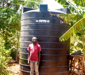 Felicio Fundi is a young, dedicated farmer residing in Rianjeru village, Mbeti South, Embu County. He is a loving husband and also a proud father of one. Felicio bears the essential responsibility of providing for his family, and he achieves this through a diverse array of agricultural pursuits, including dairy farming, pawpaw cultivation, and banana farming. In the semi-arid region of Rianjeru, clean water is scarce. The community depends on the "Rupingazi Rweru" water project, funded by the World Bank, but water is only available on specific days. During dry seasons, residents often go an entire week without any water. Felicio and his young family faced significant challenges, struggling to secure enough water for their crops, livestock, and daily needs. They often stayed up all night collecting and storing water when it's accessible, leaving them vulnerable to bandits and troublemakers who exploit the darkness. This situation made life difficult and dangerous for them. This predicament weighed heavily on Felicio, as it began to slow down his ability to manage the day-to-day activities on his farm. At times, he resorted to hiring a water tanker, which came at a steep cost of Ksh 3,000 for 6,000 liters of water, necessitating five deliveries in a month. This was not only financially burdensome but also unsustainable in the long run. Felicio yearned for a lasting and secure water solution for his family. Fortunately, Felicio was a member of BIMAS Microfinance, where he had been tapping into loans to support his farming endeavors. In March 2021, he received news that BIMAS was offering financing for water tanks to its customers. This was a golden opportunity for him to finally experience an abundance of water in his home. With the support of BIMAS, Felicio secured a loan of Ksh 78,000, enabling him to purchase and install a substantial 10,000-liter water tank on his property. The transformation was worth it. The family was no longer at the mercy of dry seasons; they now had a reliable and ample water supply for both their domestic needs and farming activities. Felicio's family life took a turn for the better. He radiated happiness as a father and husband. With their newfound water security, the family harbors ambitious plans to expand their farming enterprise. They even own another farm situated near a river, and BIMAS's support extends to financing the purchase of a water pump for this venture. In Felicio's own words, he joyfully exclaims, "I can now farm with confidence throughout the year. My small-scale farming business has thrived since partnering with BIMAS. We are no longer constrained, and our lives are no longer endangered during the night. We can rest early and wake up refreshed to tend to our farming." Felicio’s success story highlights BIMAS Microfinance's commitment to Sustainable Development Goal 6 by ensuring sustainable water management. By financing water tanks and pumps, BIMAS tackles water scarcity in semi-arid regions like Rianjeru, enhancing farmers' quality of life and promoting sustainable agriculture. This support boosts both economic and social well-being in the community, demonstrating a commitment to improving water access and management.