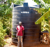 Felicio Fundi is a young, dedicated farmer residing in Rianjeru village, Mbeti South, Embu County. He is a loving husband and also a proud father of one. Felicio bears the essential responsibility of providing for his family, and he achieves this through a diverse array of agricultural pursuits, including dairy farming, pawpaw cultivation, and banana farming. In the semi-arid region of Rianjeru, clean water is scarce. The community depends on the "Rupingazi Rweru" water project, funded by the World Bank, but water is only available on specific days. During dry seasons, residents often go an entire week without any water. Felicio and his young family faced significant challenges, struggling to secure enough water for their crops, livestock, and daily needs. They often stayed up all night collecting and storing water when it's accessible, leaving them vulnerable to bandits and troublemakers who exploit the darkness. This situation made life difficult and dangerous for them. This predicament weighed heavily on Felicio, as it began to slow down his ability to manage the day-to-day activities on his farm. At times, he resorted to hiring a water tanker, which came at a steep cost of Ksh 3,000 for 6,000 liters of water, necessitating five deliveries in a month. This was not only financially burdensome but also unsustainable in the long run. Felicio yearned for a lasting and secure water solution for his family. Fortunately, Felicio was a member of BIMAS Microfinance, where he had been tapping into loans to support his farming endeavors. In March 2021, he received news that BIMAS was offering financing for water tanks to its customers. This was a golden opportunity for him to finally experience an abundance of water in his home. With the support of BIMAS, Felicio secured a loan of Ksh 78,000, enabling him to purchase and install a substantial 10,000-liter water tank on his property. The transformation was worth it. The family was no longer at the mercy of dry seasons; they now had a reliable and ample water supply for both their domestic needs and farming activities. Felicio's family life took a turn for the better. He radiated happiness as a father and husband. With their newfound water security, the family harbors ambitious plans to expand their farming enterprise. They even own another farm situated near a river, and BIMAS's support extends to financing the purchase of a water pump for this venture. In Felicio's own words, he joyfully exclaims, "I can now farm with confidence throughout the year. My small-scale farming business has thrived since partnering with BIMAS. We are no longer constrained, and our lives are no longer endangered during the night. We can rest early and wake up refreshed to tend to our farming." Felicio’s success story highlights BIMAS Microfinance's commitment to Sustainable Development Goal 6 by ensuring sustainable water management. By financing water tanks and pumps, BIMAS tackles water scarcity in semi-arid regions like Rianjeru, enhancing farmers' quality of life and promoting sustainable agriculture. This support boosts both economic and social well-being in the community, demonstrating a commitment to improving water access and management.