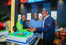 From Left: KCB Regional Business Manager, Moi Avenue Branch - Leah Choge, Joshua Ochieng (a parent) and Senior Business Development Manager, Personal Banking, Nelson Wanyonyi, cut a cake to commemorate the launch of KCB Under 18 Proposition at Garden City Mall, Nairobi.