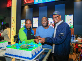 From Left: KCB Regional Business Manager, Moi Avenue Branch - Leah Choge, Joshua Ochieng (a parent) and Senior Business Development Manager, Personal Banking, Nelson Wanyonyi, cut a cake to commemorate the launch of KCB Under 18 Proposition at Garden City Mall, Nairobi.