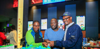 From Left: KCB Regional Business Manager, Moi Avenue Branch - Leah Choge, Joshua Ochieng (a parent) and Senior Business Development Manager, Personal Banking, Nelson Wanyonyi, cut a cake to commemorate the launch of KCB Under 18 Proposition at Garden City Mall, Nairobi.