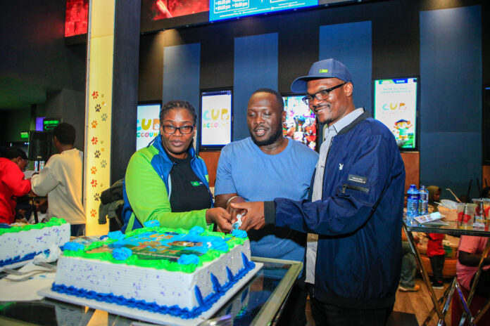 From Left: KCB Regional Business Manager, Moi Avenue Branch - Leah Choge, Joshua Ochieng (a parent) and Senior Business Development Manager, Personal Banking, Nelson Wanyonyi, cut a cake to commemorate the launch of KCB Under 18 Proposition at Garden City Mall, Nairobi.
