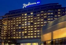Radisson Hotel Group has reached a significant milestone in Africa, with more than 100 hotels across the continent in operation and under development. Radisson Blu continues to anchor the legacy footprint. At the same time, the Radisson brand is the fastest riser, supported by a strong conversion engine and a concrete pipeline that continues to translate into openings. Building on this momentum, the Group has signed over 15 new hotels and roughly 2,500 rooms in the last 12 months, including new market entries in the Democratic Republic of Congo and Zimbabwe. This week, Radisson Hotel Group is also attending FHS Africa (www.FutureHospitality.com) in Nairobi, reinforcing its commitment to expanding its presence and strengthening strategic partnerships across the continent. Over the past five years, Radisson and Radisson Blu have ranked among the most signed brands in Africa, with one of the highest shares of cumulative openings. The last 12 months set a new benchmark with more than 2,500 rooms signed and multiple market entries. Priority growth markets remain Morocco, South Africa, and Nigeria, where the Group is deepening its presence and widening its brand distribution. Ramsay Rankoussi, Regional Chief Development Officer, Radisson Hotel Group, commented: “We’ve crossed the 100-hotel mark in Africa by staying true to our plan, focusing on where we can lead, moving fast on quality conversions, and partnering with owners who share our ambition. The next phase is about depth in Morocco and Nigeria, a smarter footprint in South Africa, and a stronger resort offering that matches where travelers want to go. Our pipeline is built to open, not just to announce. That is why our conversion share is high, our time to market is short, and our brands are gaining ground in the cities and resort destinations that matter most.” Nigeria shows the model’s resilience. The Group now holds a strong position in the country with 13 hotels in operation and pipeline, while Abuja is carrying a significant active pipeline with three hotels totaling 458 keys. South Africa is being reshaped with priorities in Cape Town, targeted growth in secondary cities such as Durban and Pretoria, and a sharper focus on leisure corridors that include Kruger National Park, Sun City, and the Garden Route. The Group plans to enter Zanzibar and is considering lodge, safari, and affiliation opportunities across Namibia, Botswana, and Zambia to meet the rising demand for nature-led experiences. Conversions remain a core lever for scale and speed. In the last five years, more than 15 hotels, equal to almost 3,000 rooms, joined the portfolio through conversion. This helped the Group lead openings across the continent while keeping brand standards high and owners in mind. Recent signings show the extensiveness of this strategy, with a balanced pipeline of city hotels, resort destinations, and quick-to-market conversions. These signings span the Democratic Republic of Congo, Nigeria, Zimbabwe, and Morocco, including Radisson Blu Kinshasa and three Radisson hotels in Lubumbashi, Radisson Harare, Park Inn Victoria Falls, Radisson Collection Lagos Atlantic, as well as new additions in Casablanca with Radisson Blu Resort & Conference Center Bouskoura, a first Radisson brand hotel in Rabat, and further expansion in Marrakech. Key signings include: Democratic Republic of the Congo Radisson Blu Hotel, Kinshasa Upper-upscale flagship in Gombe Opening late 2026. Set on Boulevard Colonel Tshatshi in the Gombe district, the hotel will offer 110 keys, including suites and a Presidential Suite. Guests can choose from a lobby bar, an all-day dining restaurant, and a pool bar. Wellness includes a gym, massage rooms, and an outdoor pool with a terrace. Meetings and events feature a modern event hall with a pre-function area. The address is well connected, 32 kilometers from N’djili International Airport, 10 kilometers from N’Dolo Airport, and 6 kilometers from Gare Centrale. Radisson Hotel Lubumbashi Panoramic city stay in the DRC’s second city Opening mid-2027. Located on Revolution Road Avenue, the hotel will feature 97 keys, including junior suites and a Presidential Suite. Dining spans a lobby bar, an all-day dining venue, and a rooftop bar and grill with city views. Three flexible meeting rooms and a pre-function area support business and social events. Facilities include a gym and a swimming pool. The location sits near Kipopo Lake, Lubumbashi Golf Club, and La Plage, and is 12 kilometers from Luano International Airport. Radisson Blu Apartments Lubumbashi Upscale apartment living in Lubumbashi’s prestigious Quartier Golf Targeted for 2030. A 160-room property located in Quartier Golf, one of Lubumbashi’s most upscale residential districts, near Kipopo Lake and surrounded by luxury homes and key landmarks including Lubumbashi Golf and La Plage. Planned amenities include a specialty restaurant and bar, a pool bar, and a gym, offering a premium stay experience for extended-stay and leisure travelers. Radisson Airport Hotel Lubumbashi A strategically located airport hotel designed for ease and connectivity Set to open in 2028, this 105-room property will be located just 6 kilometers from Luano International Airport, around a 10-minute drive, making it well positioned for business travelers, transit guests, and airline crews. Planned facilities include a restaurant, lobby bar, pool bar, meeting rooms, and a swimming pool, combining practicality with a welcoming hospitality experience close to the airport. Egypt Radisson Resort Ain Sokhna Groove A large-scale Red Sea resort in one of Egypt’s growing leisure destinations Planned for 2029, Radisson Resort Ain Sokhna Groove will offer 469 rooms, including 50 family rooms, as part of The Groove Ain Sokhna mixed-use development. Located along the Red Sea coast, around 30 kilometers south of Ain Sokhna and approximately 150 kilometers from Cairo, the resort is expected to feature private beach access, a spa, gym and fitness center, several restaurants, plus a ballroom and meeting rooms, catering to both holidaymakers and events demand. Radisson Serviced Apartments COY Sheikh Zayed City Flexible extended-stay accommodation in a fast-growing hub of Greater Cairo Expected to open in 2030, this 120-key serviced apartments property, including six one-bedroom units, will form part of the COY development in Sheikh Zayed City. With a location just 13 kilometers from Sphinx International Airport and 14 kilometers from the Great Pyramids of Giza, the development sits close to major commercial, leisure, education, and healthcare destinations. Planned amenities include a coffee lounge, bar, kiosk, and meeting and event space integrated into the wider co-working environment. Morocco Radisson Blu Hotel & Conference Center, Casablanc a Bouskoura Conference-ready address beside Palm Golf A 119-key hotel with eight suites, a rooftop restaurant, and a dedicated conference center. Event facilities include two boardrooms, while a spa and a large outdoor pool cater to leisure travelers. The hotel is located 20 kilometers from Mohammed V International Airport and next to Palm Golf Palmeraie Country Club. Radisson Hotel & Apartments Rabat Technopolis Dual-component hub in the capital’s innovation park A two-building project in Technopolis, 25 minutes from central Rabat. The hotel will offer 140 rooms, four dining venues, a pool, and a meeting and events space. The adjacent serviced apartment building adds 56 units. Technopolis connects businesses with leading education and research centers, creating a strong base for corporate demand. Radisson Blu Resort Marrakech Ben Akil Low-rise bungalows with views of Atlas Mountains Opening early 2028. A 17-hectare estate featuring 80 bungalow-style accommodations, each with an outdoor terrace. Larger typologies include private pools. The resort sits beside Royal Golf Marrakech and is a 15-minute drive from the city center. Nigeria Radisson Hotel Aba A new internationally branded hospitality destination for Aba Targeted for 2031, Radisson Hotel Aba will introduce 120 rooms, including six junior suites, in a prime riverside location along the Aba River near key transport corridors. The hotel will become the first Radisson-branded property in Aba and the Group’s third branded hotel in Nigeria. Plans for the hotel include a gym, swimming pool, and several meeting rooms, serving both business and local demand. Sam Mbakwe International Airport in Owerri is approximately 56 kilometers away, or a 1 hour and 10 minute drive. Radisson Hotel & Conference Center Yenagoa A conference-focused hotel in the heart of an emerging Nigerian business center Scheduled for 2027, the property will feature 196 rooms, including 16 junior suites, four executive suites, and two Presidential Suites, in Yenagoa, a city that is steadily strengthening its role as an administrative and commercial hub in southern Nigeria. Located near government institutions, business districts, and Bayelsa International Airport, approximately 33 kilometers or 40 minutes away, the hotel is set to benefit from the area’s ongoing infrastructure and hospitality growth while meeting rising demand for accommodation, meetings, and large-scale events. Radisson Collection Hotel, Lagos Atlantic Refined lifestyle luxury on the oceanfront of Lagos’ leading business district Targeted for 2029, Radisson Collection Hotel, Lagos Atlantic will feature 107 rooms, including 16 executive suites and one Presidential Suite, on a prime oceanfront site on Victoria Island. As Lagos’ main financial and commercial district, Victoria Island is home to multinational companies, corporate headquarters, embassies, and strong year-round business activity. Located approximately 33 kilometers from Murtala Muhammed International Airport, around a 45-minute drive, the hotel will mark the second Radisson Collection property in Lagos. South Africa Radisson Serviced Apartments Umhlanga A modern serviced apartment offering in the heart of Umhlanga’s business district Planned for 2029, Radisson Serviced Apartments Umhlanga will introduce 155 rooms in a newly built development within Umhlanga Ridge, one of the area’s most established commercial and lifestyle hubs. The property will be within walking distance of Gateway Theatre of Shopping and close to major office precincts, including Umhlanga Ridge Business Park, La Lucia Office Park, and Glass House Office Park. Comprising studios and apartments, the project is designed to meet growing demand for high-quality extended-stay accommodation in the district. Zimbabwe New market entry Radisson Serviced Apartments, Harare Prime Borrowdale address for extended stays Targeted for end-2028. A 147-key serviced apartments project within a master development near Maxwell Road in Borrowdale. The neighborhood is known for luxury residences, upscale shopping at Sam Levy’s Village, and entertainment at Borrowdale Racecourse. Planned amenities include a café and bar, a gym with sauna, and a pool with a deck. Set to be the only internationally branded hotel apartment offering in the area. Park Inn by Radisson Victoria Falls Resort A resort destination near one of the world’s most iconic natural landmarks Expected to open in 2029, Park Inn by Radisson Victoria Falls Resort will offer 150 rooms, including five suites, in a setting overlooking Zambezi National Park. Located just 5 kilometers from Victoria Falls, around a 10-minute drive, the resort will be ideally positioned near one of the Seven Natural Wonders of the World, a destination that attracts more than 350,000 international visitors each year. With year-round waterfall views, adventure tourism, and access to safari experiences in the surrounding national parks, the property will cater to both leisure travelers and tour groups. Victoria Falls Airport is located approximately 22 kilometers, or a 23-minute drive, away. Leading with the most diverse footprint across the continent, with presence in more than 30 African countries, Radisson Hotel Group blends depth in focus markets with selective entry into new destinations each year.
