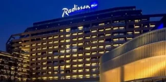 Radisson Hotel Group has reached a significant milestone in Africa, with more than 100 hotels across the continent in operation and under development. Radisson Blu continues to anchor the legacy footprint. At the same time, the Radisson brand is the fastest riser, supported by a strong conversion engine and a concrete pipeline that continues to translate into openings. Building on this momentum, the Group has signed over 15 new hotels and roughly 2,500 rooms in the last 12 months, including new market entries in the Democratic Republic of Congo and Zimbabwe. This week, Radisson Hotel Group is also attending FHS Africa (www.FutureHospitality.com) in Nairobi, reinforcing its commitment to expanding its presence and strengthening strategic partnerships across the continent. Over the past five years, Radisson and Radisson Blu have ranked among the most signed brands in Africa, with one of the highest shares of cumulative openings. The last 12 months set a new benchmark with more than 2,500 rooms signed and multiple market entries. Priority growth markets remain Morocco, South Africa, and Nigeria, where the Group is deepening its presence and widening its brand distribution. Ramsay Rankoussi, Regional Chief Development Officer, Radisson Hotel Group, commented: “We’ve crossed the 100-hotel mark in Africa by staying true to our plan, focusing on where we can lead, moving fast on quality conversions, and partnering with owners who share our ambition. The next phase is about depth in Morocco and Nigeria, a smarter footprint in South Africa, and a stronger resort offering that matches where travelers want to go. Our pipeline is built to open, not just to announce. That is why our conversion share is high, our time to market is short, and our brands are gaining ground in the cities and resort destinations that matter most.” Nigeria shows the model’s resilience. The Group now holds a strong position in the country with 13 hotels in operation and pipeline, while Abuja is carrying a significant active pipeline with three hotels totaling 458 keys. South Africa is being reshaped with priorities in Cape Town, targeted growth in secondary cities such as Durban and Pretoria, and a sharper focus on leisure corridors that include Kruger National Park, Sun City, and the Garden Route. The Group plans to enter Zanzibar and is considering lodge, safari, and affiliation opportunities across Namibia, Botswana, and Zambia to meet the rising demand for nature-led experiences. Conversions remain a core lever for scale and speed. In the last five years, more than 15 hotels, equal to almost 3,000 rooms, joined the portfolio through conversion. This helped the Group lead openings across the continent while keeping brand standards high and owners in mind. Recent signings show the extensiveness of this strategy, with a balanced pipeline of city hotels, resort destinations, and quick-to-market conversions. These signings span the Democratic Republic of Congo, Nigeria, Zimbabwe, and Morocco, including Radisson Blu Kinshasa and three Radisson hotels in Lubumbashi, Radisson Harare, Park Inn Victoria Falls, Radisson Collection Lagos Atlantic, as well as new additions in Casablanca with Radisson Blu Resort & Conference Center Bouskoura, a first Radisson brand hotel in Rabat, and further expansion in Marrakech. Key signings include: Democratic Republic of the Congo Radisson Blu Hotel, Kinshasa Upper-upscale flagship in Gombe Opening late 2026. Set on Boulevard Colonel Tshatshi in the Gombe district, the hotel will offer 110 keys, including suites and a Presidential Suite. Guests can choose from a lobby bar, an all-day dining restaurant, and a pool bar. Wellness includes a gym, massage rooms, and an outdoor pool with a terrace. Meetings and events feature a modern event hall with a pre-function area. The address is well connected, 32 kilometers from N’djili International Airport, 10 kilometers from N’Dolo Airport, and 6 kilometers from Gare Centrale. Radisson Hotel Lubumbashi Panoramic city stay in the DRC’s second city Opening mid-2027. Located on Revolution Road Avenue, the hotel will feature 97 keys, including junior suites and a Presidential Suite. Dining spans a lobby bar, an all-day dining venue, and a rooftop bar and grill with city views. Three flexible meeting rooms and a pre-function area support business and social events. Facilities include a gym and a swimming pool. The location sits near Kipopo Lake, Lubumbashi Golf Club, and La Plage, and is 12 kilometers from Luano International Airport. Radisson Blu Apartments Lubumbashi Upscale apartment living in Lubumbashi’s prestigious Quartier Golf Targeted for 2030. A 160-room property located in Quartier Golf, one of Lubumbashi’s most upscale residential districts, near Kipopo Lake and surrounded by luxury homes and key landmarks including Lubumbashi Golf and La Plage. Planned amenities include a specialty restaurant and bar, a pool bar, and a gym, offering a premium stay experience for extended-stay and leisure travelers. Radisson Airport Hotel Lubumbashi A strategically located airport hotel designed for ease and connectivity Set to open in 2028, this 105-room property will be located just 6 kilometers from Luano International Airport, around a 10-minute drive, making it well positioned for business travelers, transit guests, and airline crews. Planned facilities include a restaurant, lobby bar, pool bar, meeting rooms, and a swimming pool, combining practicality with a welcoming hospitality experience close to the airport. Egypt Radisson Resort Ain Sokhna Groove A large-scale Red Sea resort in one of Egypt’s growing leisure destinations Planned for 2029, Radisson Resort Ain Sokhna Groove will offer 469 rooms, including 50 family rooms, as part of The Groove Ain Sokhna mixed-use development. Located along the Red Sea coast, around 30 kilometers south of Ain Sokhna and approximately 150 kilometers from Cairo, the resort is expected to feature private beach access, a spa, gym and fitness center, several restaurants, plus a ballroom and meeting rooms, catering to both holidaymakers and events demand. Radisson Serviced Apartments COY Sheikh Zayed City Flexible extended-stay accommodation in a fast-growing hub of Greater Cairo Expected to open in 2030, this 120-key serviced apartments property, including six one-bedroom units, will form part of the COY development in Sheikh Zayed City. With a location just 13 kilometers from Sphinx International Airport and 14 kilometers from the Great Pyramids of Giza, the development sits close to major commercial, leisure, education, and healthcare destinations. Planned amenities include a coffee lounge, bar, kiosk, and meeting and event space integrated into the wider co-working environment. Morocco Radisson Blu Hotel & Conference Center, Casablanc a Bouskoura Conference-ready address beside Palm Golf A 119-key hotel with eight suites, a rooftop restaurant, and a dedicated conference center. Event facilities include two boardrooms, while a spa and a large outdoor pool cater to leisure travelers. The hotel is located 20 kilometers from Mohammed V International Airport and next to Palm Golf Palmeraie Country Club. Radisson Hotel & Apartments Rabat Technopolis Dual-component hub in the capital’s innovation park A two-building project in Technopolis, 25 minutes from central Rabat. The hotel will offer 140 rooms, four dining venues, a pool, and a meeting and events space. The adjacent serviced apartment building adds 56 units. Technopolis connects businesses with leading education and research centers, creating a strong base for corporate demand. Radisson Blu Resort Marrakech Ben Akil Low-rise bungalows with views of Atlas Mountains Opening early 2028. A 17-hectare estate featuring 80 bungalow-style accommodations, each with an outdoor terrace. Larger typologies include private pools. The resort sits beside Royal Golf Marrakech and is a 15-minute drive from the city center. Nigeria Radisson Hotel Aba A new internationally branded hospitality destination for Aba Targeted for 2031, Radisson Hotel Aba will introduce 120 rooms, including six junior suites, in a prime riverside location along the Aba River near key transport corridors. The hotel will become the first Radisson-branded property in Aba and the Group’s third branded hotel in Nigeria. Plans for the hotel include a gym, swimming pool, and several meeting rooms, serving both business and local demand. Sam Mbakwe International Airport in Owerri is approximately 56 kilometers away, or a 1 hour and 10 minute drive. Radisson Hotel & Conference Center Yenagoa A conference-focused hotel in the heart of an emerging Nigerian business center Scheduled for 2027, the property will feature 196 rooms, including 16 junior suites, four executive suites, and two Presidential Suites, in Yenagoa, a city that is steadily strengthening its role as an administrative and commercial hub in southern Nigeria. Located near government institutions, business districts, and Bayelsa International Airport, approximately 33 kilometers or 40 minutes away, the hotel is set to benefit from the area’s ongoing infrastructure and hospitality growth while meeting rising demand for accommodation, meetings, and large-scale events. Radisson Collection Hotel, Lagos Atlantic Refined lifestyle luxury on the oceanfront of Lagos’ leading business district Targeted for 2029, Radisson Collection Hotel, Lagos Atlantic will feature 107 rooms, including 16 executive suites and one Presidential Suite, on a prime oceanfront site on Victoria Island. As Lagos’ main financial and commercial district, Victoria Island is home to multinational companies, corporate headquarters, embassies, and strong year-round business activity. Located approximately 33 kilometers from Murtala Muhammed International Airport, around a 45-minute drive, the hotel will mark the second Radisson Collection property in Lagos. South Africa Radisson Serviced Apartments Umhlanga A modern serviced apartment offering in the heart of Umhlanga’s business district Planned for 2029, Radisson Serviced Apartments Umhlanga will introduce 155 rooms in a newly built development within Umhlanga Ridge, one of the area’s most established commercial and lifestyle hubs. The property will be within walking distance of Gateway Theatre of Shopping and close to major office precincts, including Umhlanga Ridge Business Park, La Lucia Office Park, and Glass House Office Park. Comprising studios and apartments, the project is designed to meet growing demand for high-quality extended-stay accommodation in the district. Zimbabwe New market entry Radisson Serviced Apartments, Harare Prime Borrowdale address for extended stays Targeted for end-2028. A 147-key serviced apartments project within a master development near Maxwell Road in Borrowdale. The neighborhood is known for luxury residences, upscale shopping at Sam Levy’s Village, and entertainment at Borrowdale Racecourse. Planned amenities include a café and bar, a gym with sauna, and a pool with a deck. Set to be the only internationally branded hotel apartment offering in the area. Park Inn by Radisson Victoria Falls Resort A resort destination near one of the world’s most iconic natural landmarks Expected to open in 2029, Park Inn by Radisson Victoria Falls Resort will offer 150 rooms, including five suites, in a setting overlooking Zambezi National Park. Located just 5 kilometers from Victoria Falls, around a 10-minute drive, the resort will be ideally positioned near one of the Seven Natural Wonders of the World, a destination that attracts more than 350,000 international visitors each year. With year-round waterfall views, adventure tourism, and access to safari experiences in the surrounding national parks, the property will cater to both leisure travelers and tour groups. Victoria Falls Airport is located approximately 22 kilometers, or a 23-minute drive, away. Leading with the most diverse footprint across the continent, with presence in more than 30 African countries, Radisson Hotel Group blends depth in focus markets with selective entry into new destinations each year.